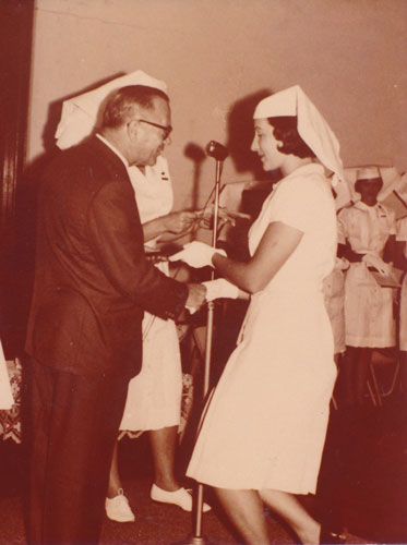 Sister Daphne June McMillan receiving her certificate from Health Minister S. D. Tooth in late 1968