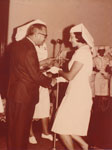 Sister Daphne June McMillan receiving her certificate from Health Minister S. D. Tooth in late 1968