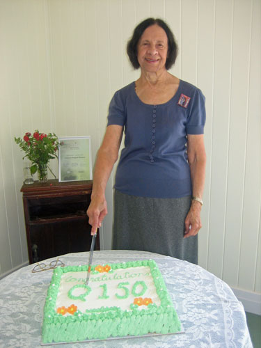 Norma West with the Q150 cake at a function to showcase the new Country Hospital Museum Building