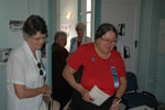 Elaine McMillan and Carol Smith review historic photographs and documents